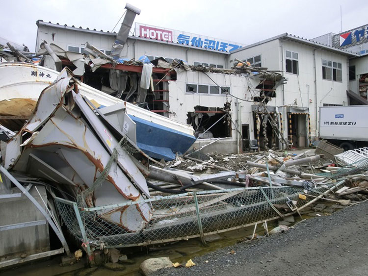 気仙沼ほてい本社工場外観（手前に魚船が流れ着いている）